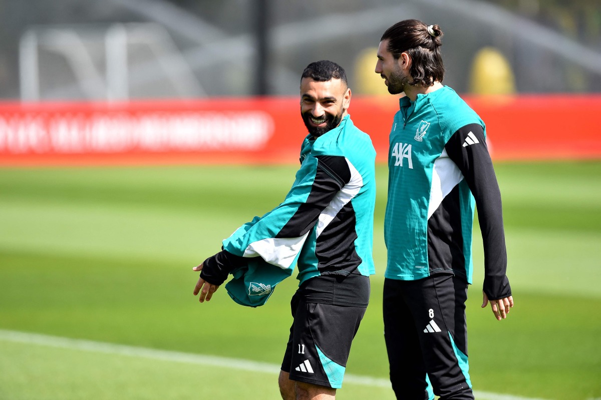 Liverpool's Egyptian striker #11 Mohamed Salah and Liverpool's Hungarian midfielder #08 Dominik Szoboszlai (R) attend a team training session at their training ground in Kirkby, Liverpool, north-west England on April 13, 2026, on the eve of their UEFA Champions League, quarter final second leg football match against Paris Saint-Germain. (Photo by PETER POWELL / AFP)