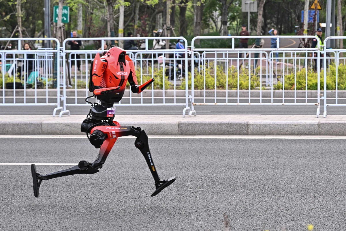 A robot runs in the second Beijing E-Town Half Marathon and humanoid Half Marathon in Beijing on April 19, 2026. Photo by Pedro PARDO / AFP