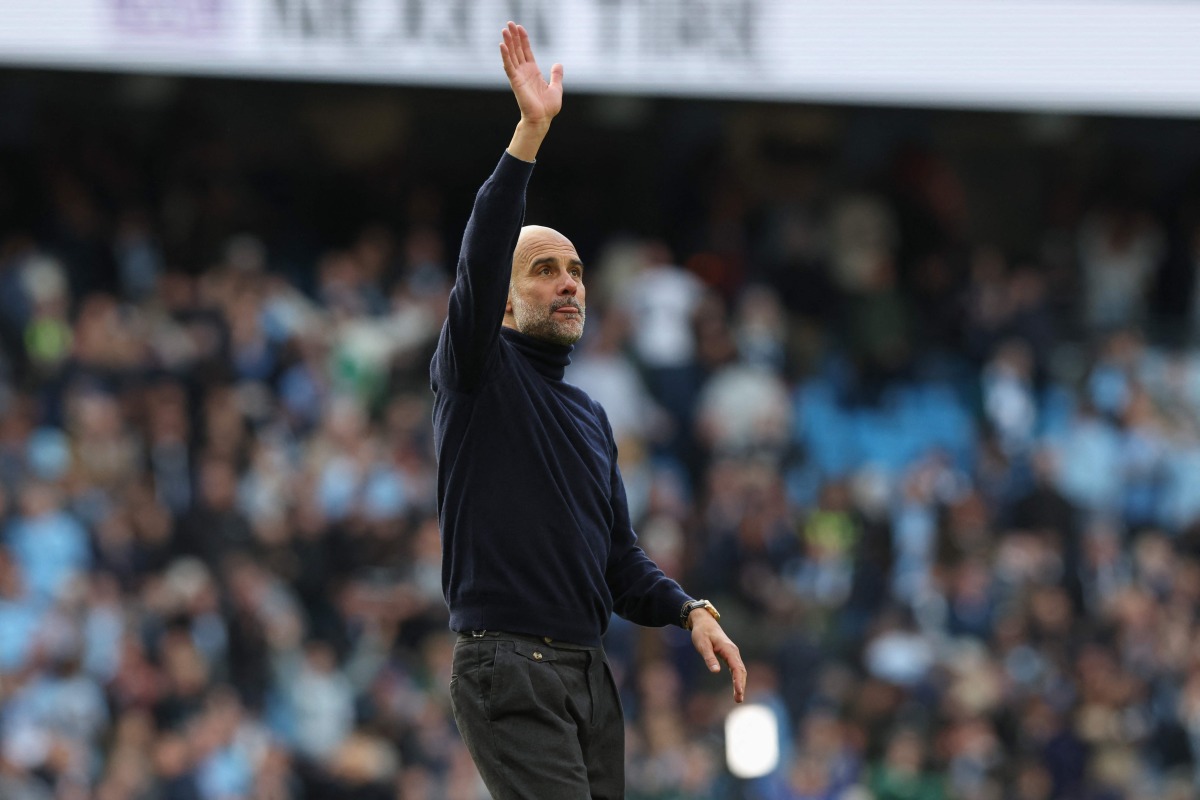 Manchester City's Spanish manager Pep Guardiola waves at the end of the English Premier League football match between Manchester City and Arsenal at the Etihad Stadium in Manchester, north west England, on April 19, 2026. (Photo by Darren Staples / AFP)