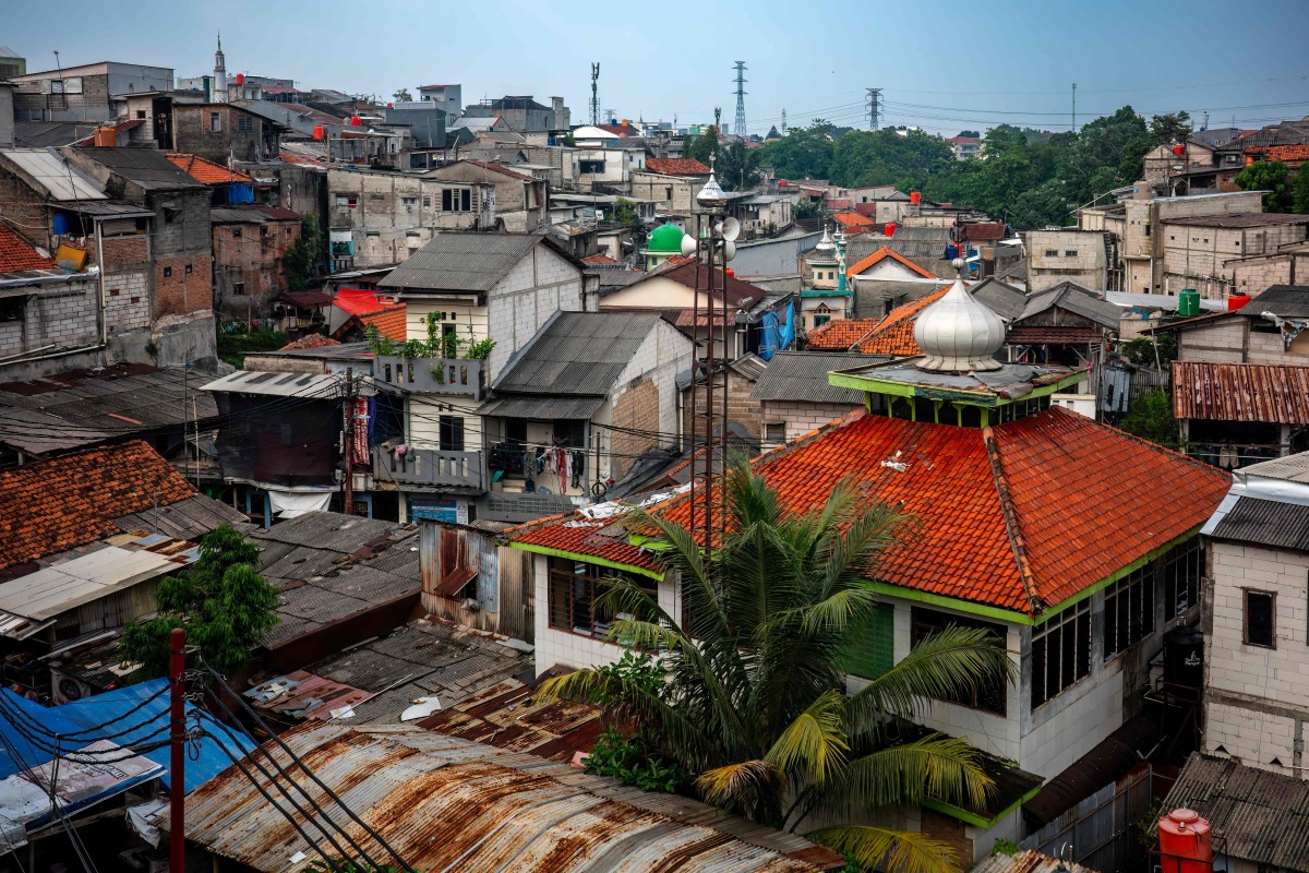 Houses are seen in a densely populated neighbourhood in Jakarta on April 21, 2026. (Photo by BAY ISMOYO / AFP)
