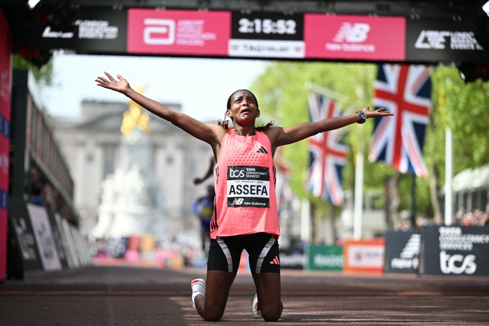 ATHLETICS-GBR-MARATHON
Ethiopia's Tigst Assefa reacts after crossing the line to win the women's race in a new women's only world record at the 2026 London Marathon in central London on April 26, 2026. 
(Photo by JUSTIN TALLIS / AFP) 