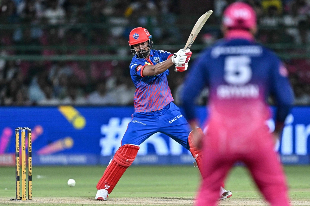Delhi Capitals' Indian cricket player KL Rahul (L) plays a shot during the 2026 Indian Premier League (IPL) T20 match between Rajasthan Royals and Delhi Capitals at the Sawai Mansingh Stadium in Jaipur on May 1, 2026. (Photo by Manan Vatsyayana / AFP) 