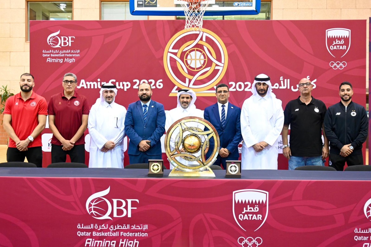 Qatar Basketball Federation, Al Arabi and Al Sadd officials, along with players pose for a photo.