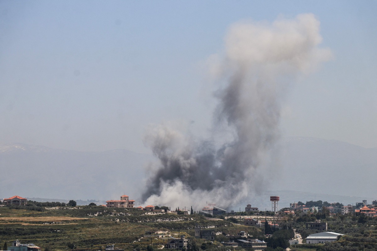 Smoke rises from the site of an Israeli airstrike that targeted the southern Lebanese village of al-Halloussiyah on May 8, 2026. (Photo by KAWNAT HAJU / AFP)