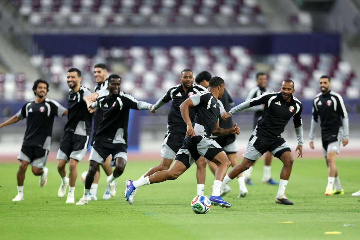 Qatar players take part in a training session. RIGHT: Coach Julen Lopetegui reacts during the session.