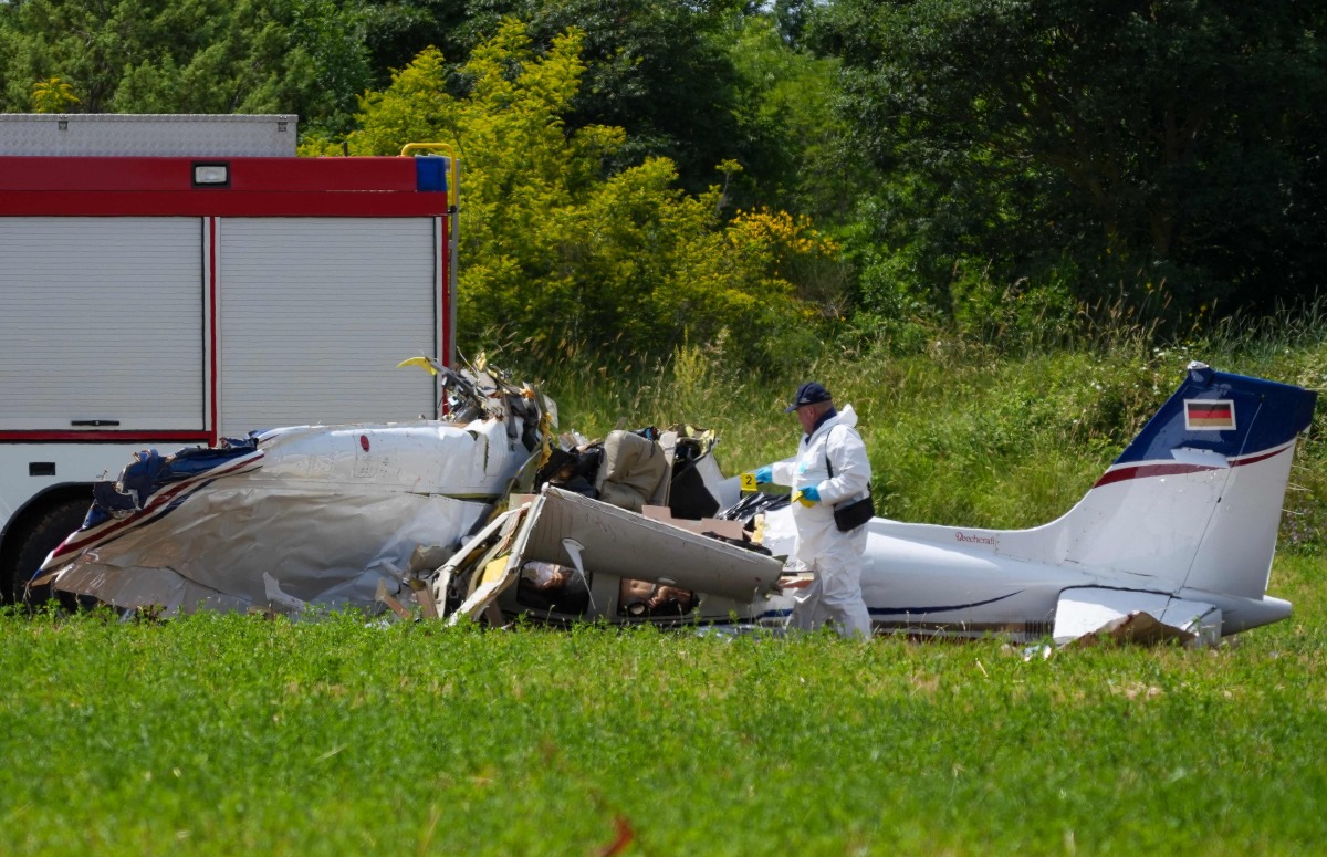 A police officer in protective gear collects evidences at site of a small plane crash, which killed 4 people, in Medulin on Croatia's northern Adriatic coast, on June 4, 2026. Photo by AFP