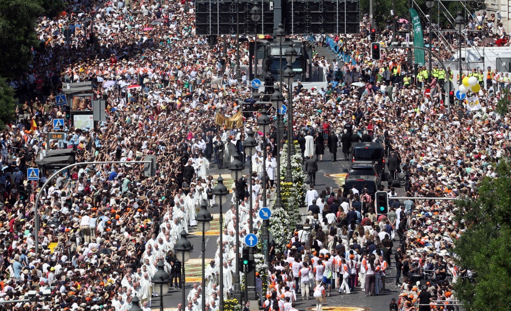 The crowd packs Alcala street as Pope Leo XIV walks under a processional canopy in Madrid on June 7, 2026. (Photo by Pierre-Philippe Marcou / AFP)