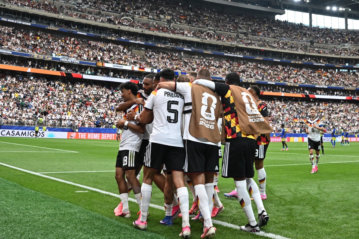 Germany's defender #18 Nathaniel Brown (C) celebrates with teammates after scoring his team's fifth goal during the 2026 World Cup Group E football match between Germany and Curacao at the Houston Stadium in Houston on June 14, 2026.
(Photo by RONALDO SCHEMIDT / AFP)