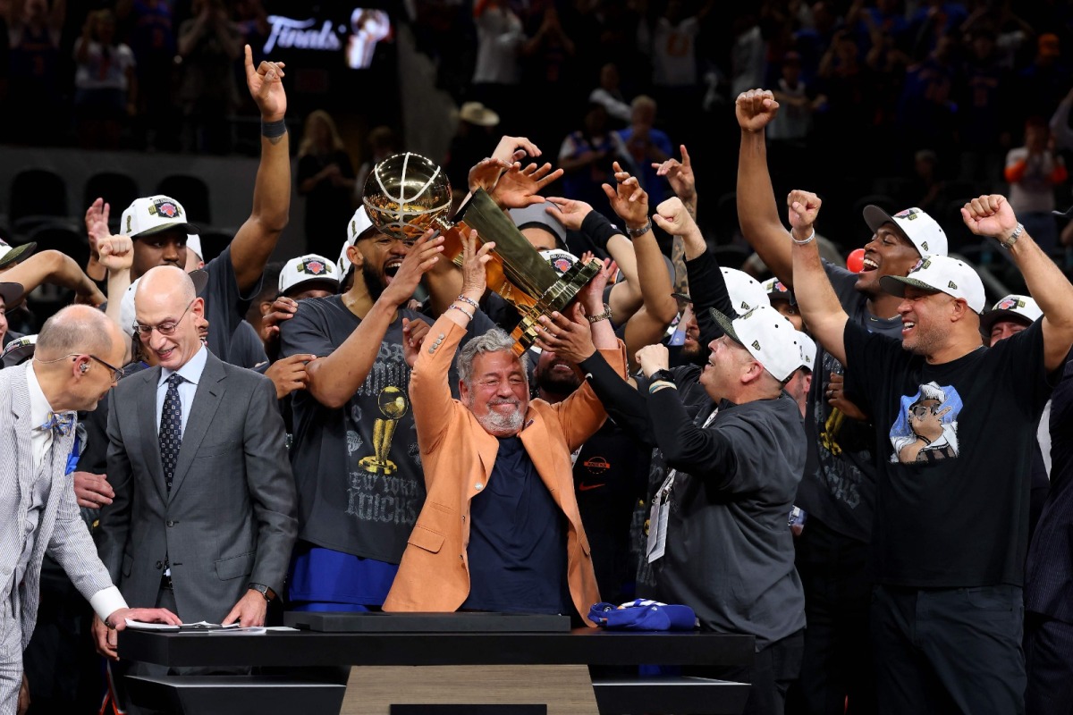 New York Knicks owner James Dolan lifts the Larry O'Brien Championship Trophy after his team defeated the San Antonio Spurs in Game Five of the 2026 NBA Finals at Frost Bank Center on June 13, 2026 in San Antonio, Texas. Gregory Shamus/Getty Images/AFP (Photo by Gregory Shamus / GETTY IMAGES NORTH AMERICA / Getty Images via AFP)