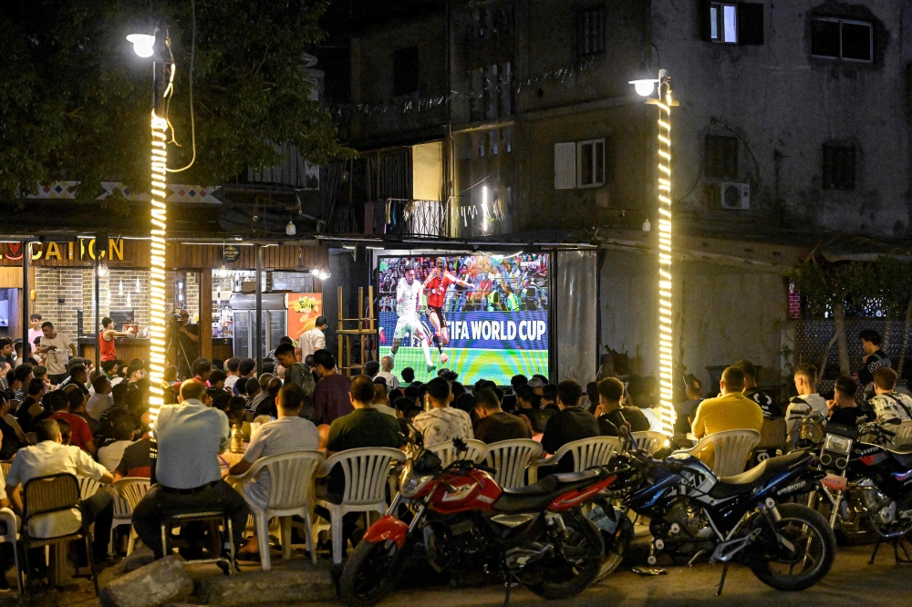 Egyptian football fans watch their national team's 2026 World Cup Group G football match against Belgium, at an outdoor cafe in the Sharabiya district of Cairo on June 15, 2026. (Photo by Khaled Desouki / various sources / AFP)