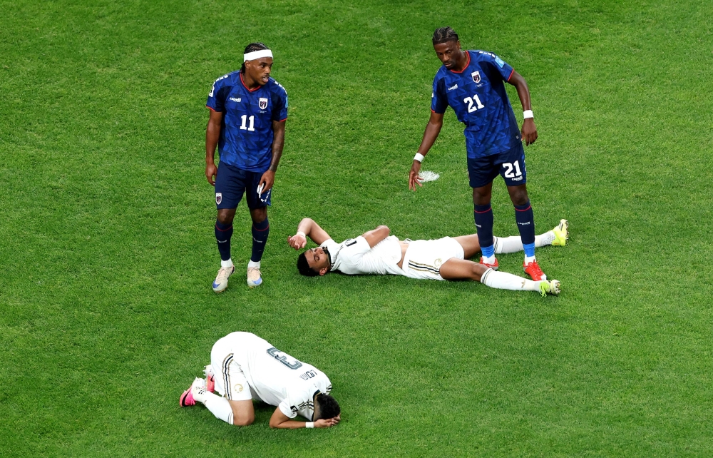 Abdulelah Al-Amri #4 and Ali Lajami #3 of Saudi Arabia react after the 0-0 draw during the FIFA World Cup 2026 Group H match between Cabo Verde and Saudi Arabia at Houston Stadium on June 26, 2026 in Houston, Texas. Charlotte Wilson/Getty Images/AFP