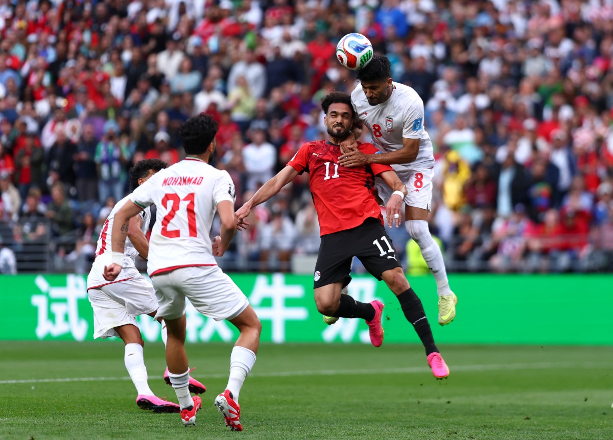 SEATTLE, WASHINGTON - JUNE 26: Mostafa Zico #11 of Egypt competes for a header against Emam Ashour #8 of Egypt during the FIFA World Cup 2026 Group G match between Egypt and IR Iran at Seattle Stadium on June 26, 2026 in Seattle, Washington.  (Photo by Dean Mouhtaropoulos / GETTY IMAGES NORTH AMERICA / Getty Images via AFP)
