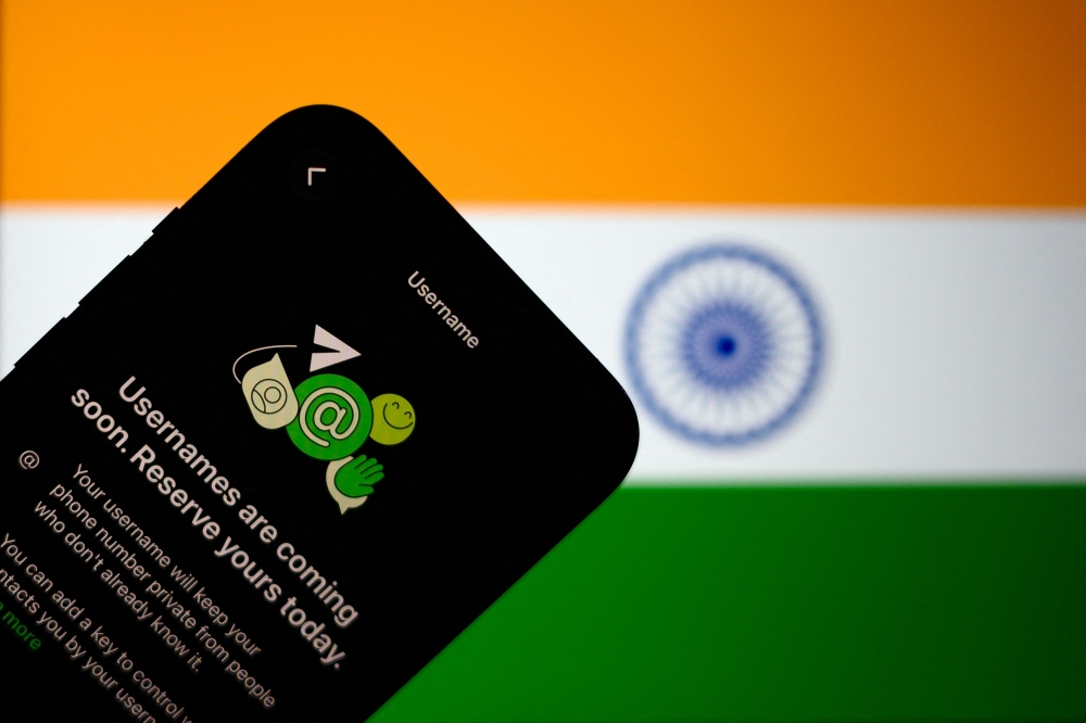 This illustration photograph taken on July 2, 2026, shows the new upcoming Usernamer feature on US instant messaging software WhatsApp, displayed on a smartphone with the backdrop of India's national flag in New Delhi. (Photo by Manan Vatsyayana / AFP)