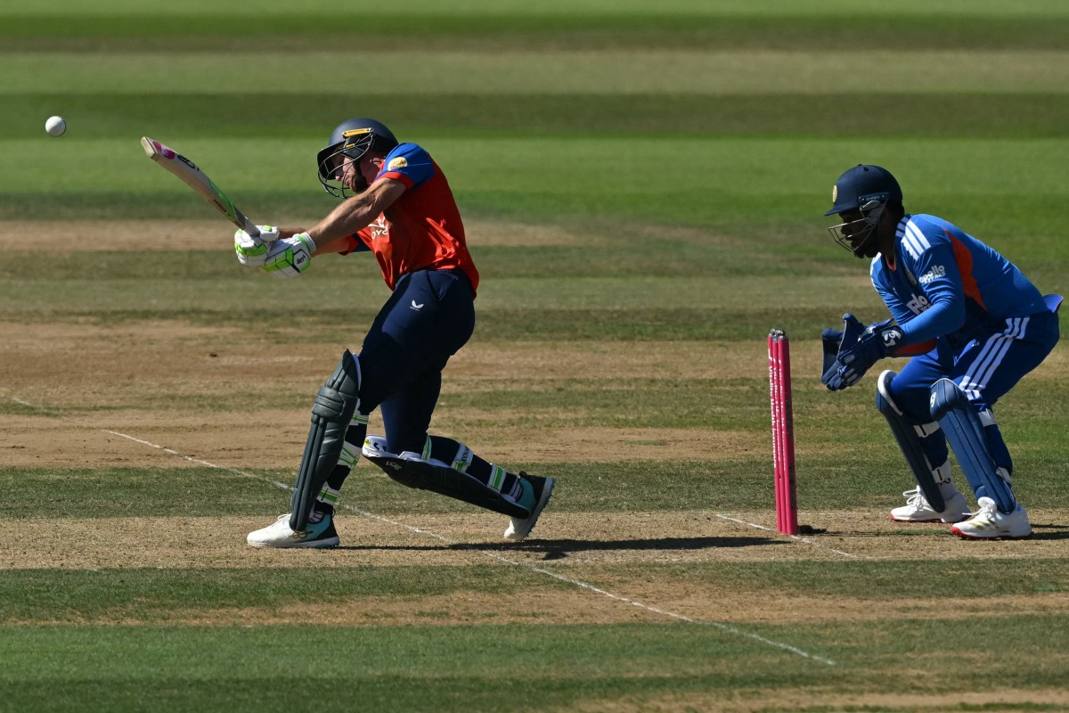 England's Jos Buttler hits a boundary as India's Sanju Samson keeps wicket during the fifth Twenty20 (T20) International cricket match between England and India at Utilita Bowl in Southampton on July 11, 2026. (Photo by JUSTIN TALLIS / AFP)