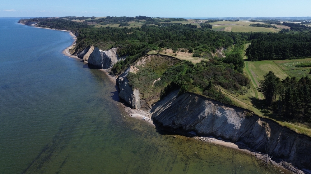 This aerial view shows the Hanklit cliff overlooking Limfjord on the Danish island of Mors, Denmark on July 9, 2026. (Photo by James Brooks / AFP)