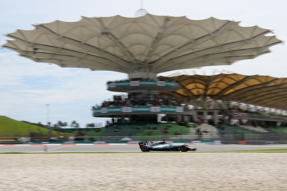 (Files) Then Mercedes's British driver Lewis Hamilton drives his car during the third practice session of the Formula One Malaysia Grand Prix in Sepang on September 30, 2017. (Photo by Manan Vatsyayana / AFP)