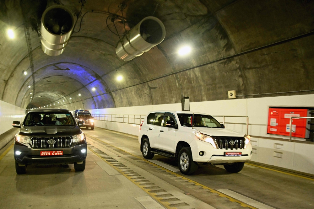 Vehicles ride through the newly inaugurated Nagdhunga tunnel, Nepal's first modern road tunnel, on the outskirts of Kathmandu on July 27, 2026. (Photo by Prakash MATHEMA / AFP)