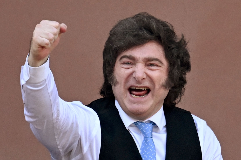 (FILES) Argentina's President Javier Milei gestures from the balcony of Casa Rosada presidential palace after a Te Deum marking the 216th anniversary of the May Revolution that led to Argentina's independence from Spain, in Buenos Aires on May 25, 2026. (Photo by Luis ROBAYO / AFP)