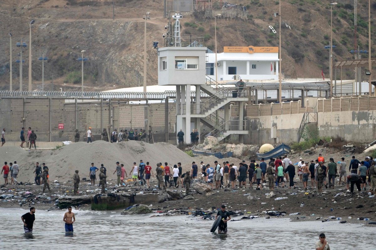 Migrants swim through the waters close to border the with Morocco to enter Spain's north Africa's Ceuta enclave on July 31, 2026. Photo by JORGE GUERRERO / AFP