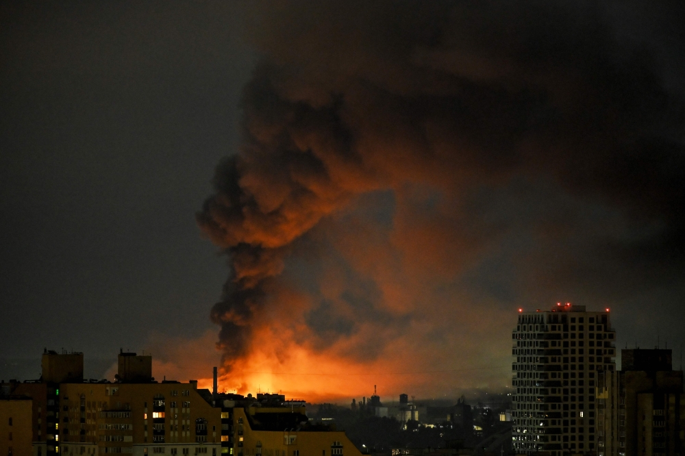 Smoke rises above residential buildings following an air attack in Kyiv on August 1, 2026. (Photo by Eugene Kotenko / AFP)
 