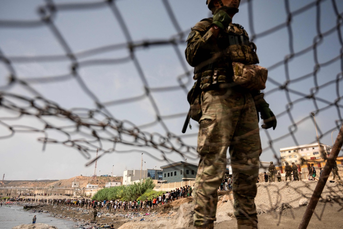 Migrants cross back to Morocco after they crossed the border to enter Spain's north Africa's Ceuta enclave on July 31, 2026. (Photo by JORGE GUERRERO / AFP)
