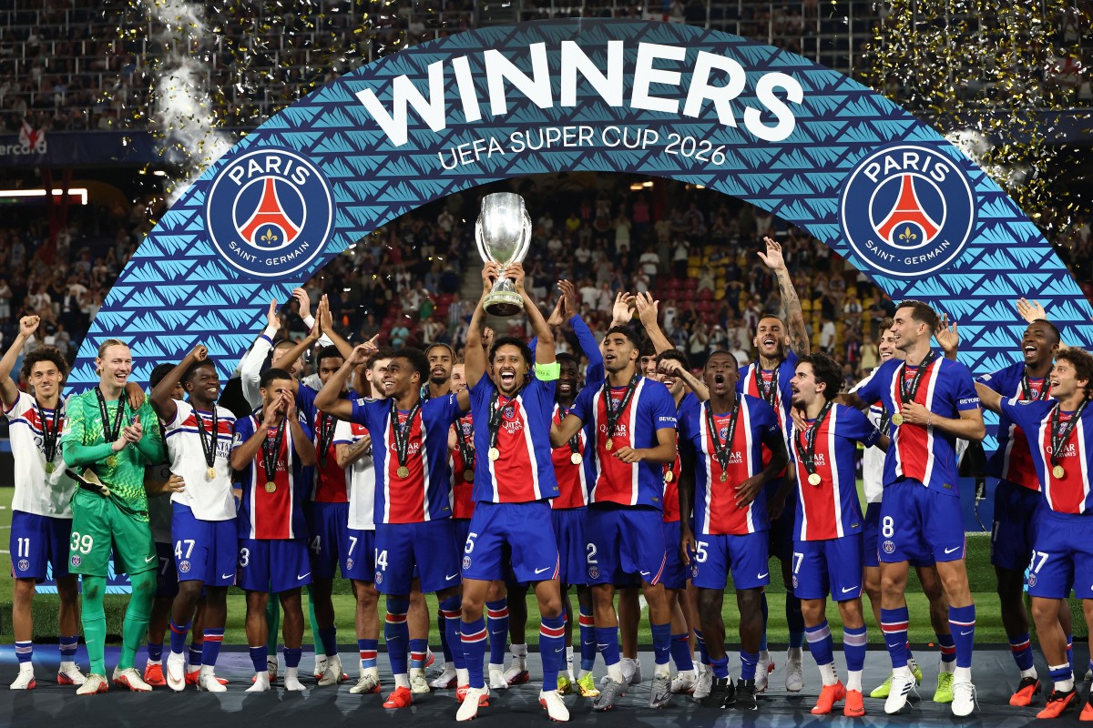 PSG players including Paris Saint-Germain's Brazilian defender #05 Marquinhos celebrate with the trophy after winning the UEFA Supercup football match between Champions League winners Paris Saint Germain (PSG) and Europa League winners Aston Villa in Salzburg, Austria on August 12, 2026. (Photo by FRANCK FIFE / AFP)