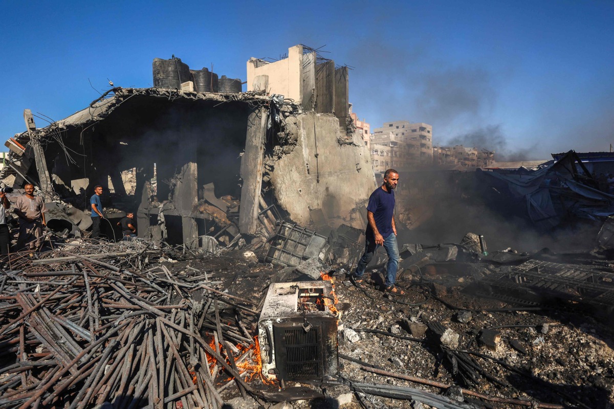 Palestinians inspect the damage at the site of an Israeli airstrike in Gaza City on August 24, 2026. (Photo by Omar AL-QATTAA / AFP)