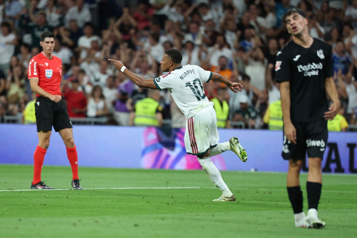 Real Madrid's French forward #10 Kylian Mbappe celebrates scoring his team's first goal during the Spanish league football match between Real Madrid CF and Real Sociedad at Santiago Bernabeu Stadium in Madrid on August 26, 2026. (Photo by Thomas COEX / AFP)