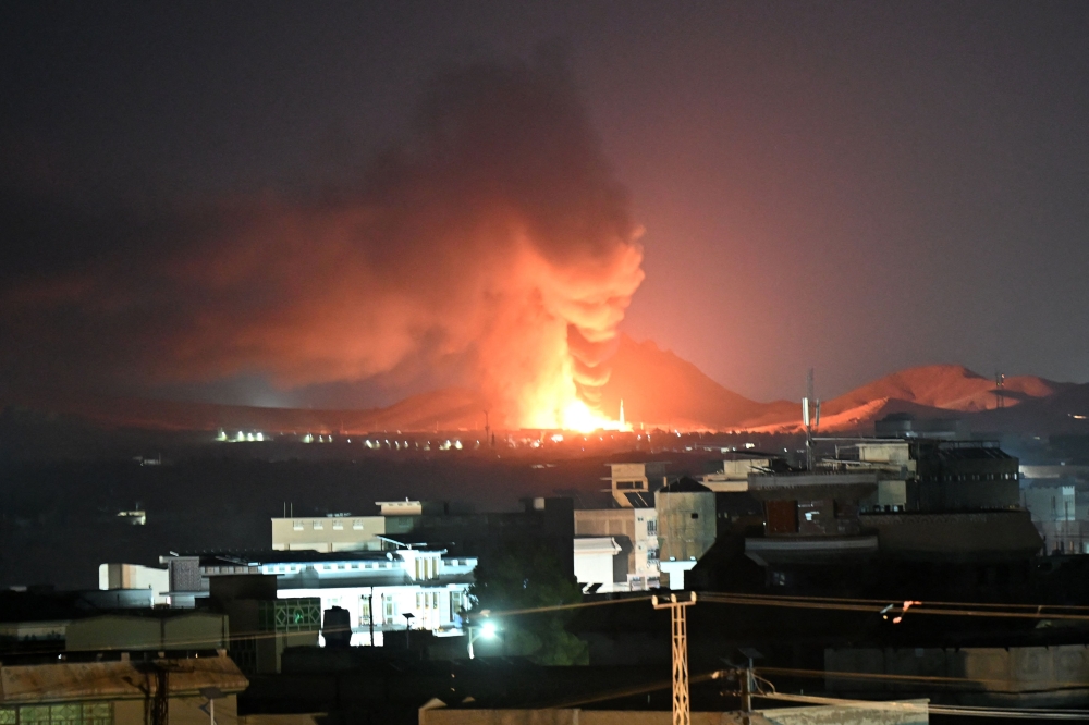 Flames and smoke rise from an area struck by an airstrike in Kandahar on September 24, 2026. (Photo by AFP)