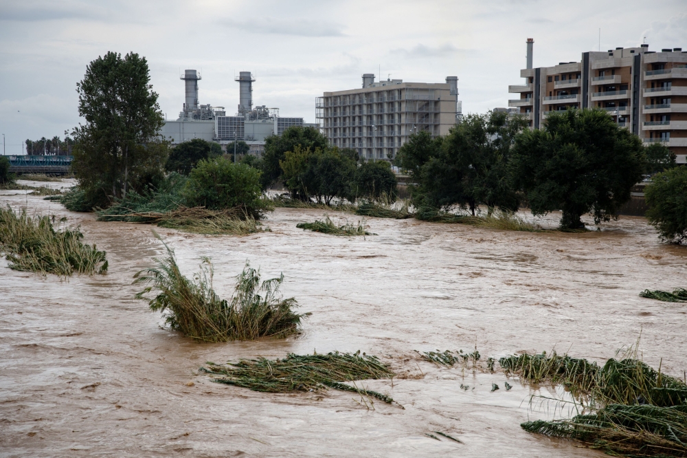 The swollen Besos River flows through Sant Adria de Besos following torrential rains on the outskirts of Barcelona, on October 4, 2026. (Photo by Josep Lago / AFP)