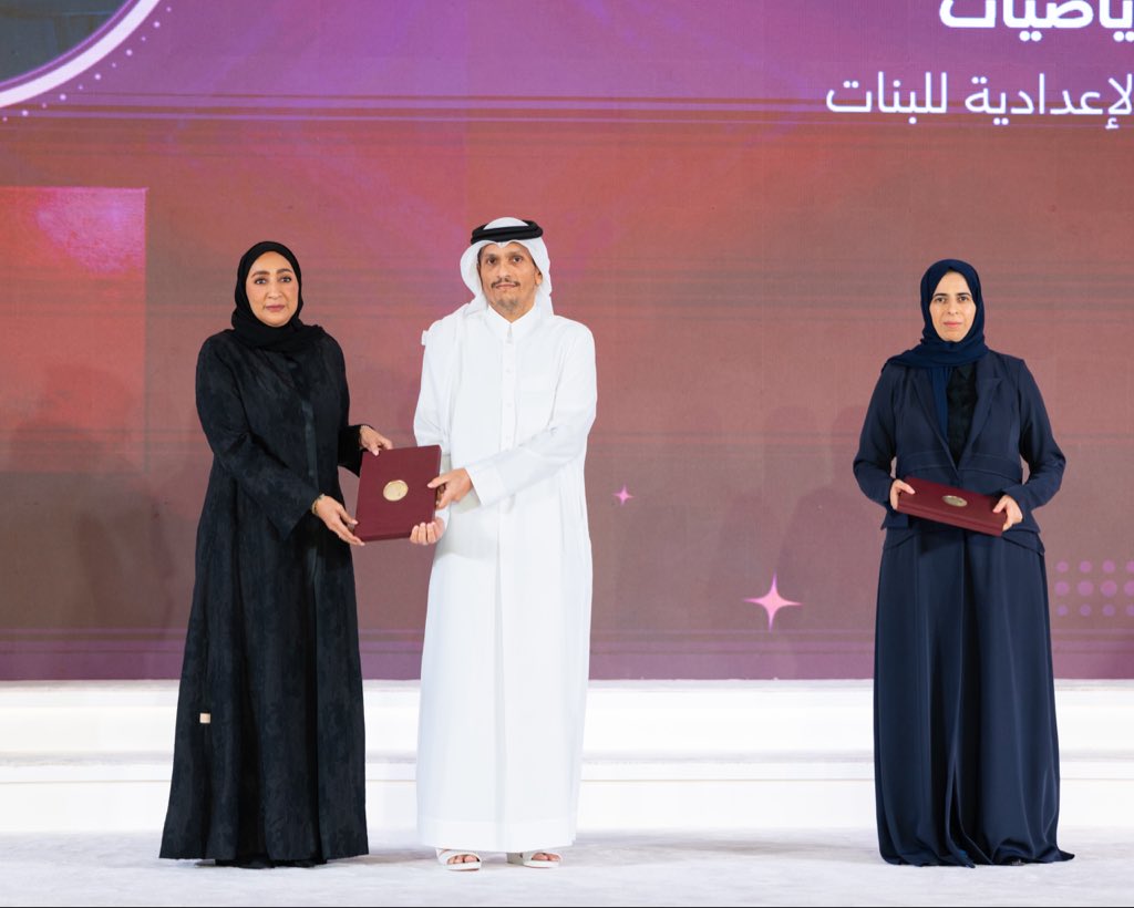 Prime Minister and Minister of Foreign Affairs H E Sheikh Mohammed bin Abdulrahman Al Thani and Minister of Education and Higher Education H E Lolwah bint Rashid Al Khater honouring a teacher during the ceremony yesterday.