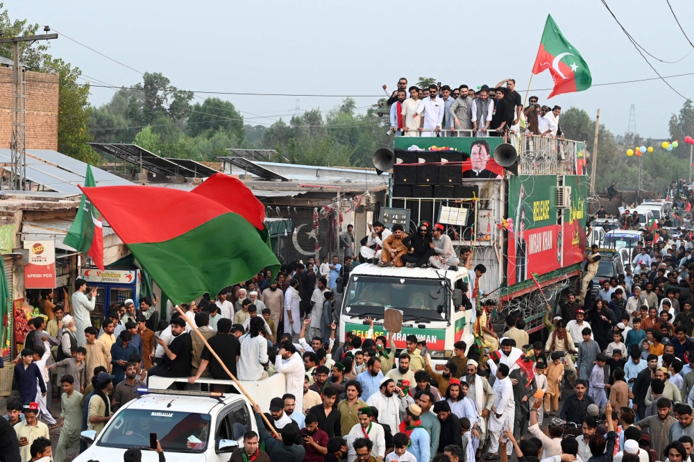 Supporters of jailed former prime minister Imran Khan's Pakistan Tehreek-e-Insaf (PTI) take part in a march in Khyber district of Pakistan's Khyber Pakhtunkhwa province on October 7, 2026. (Photo by Abdul Majeed / AFP)