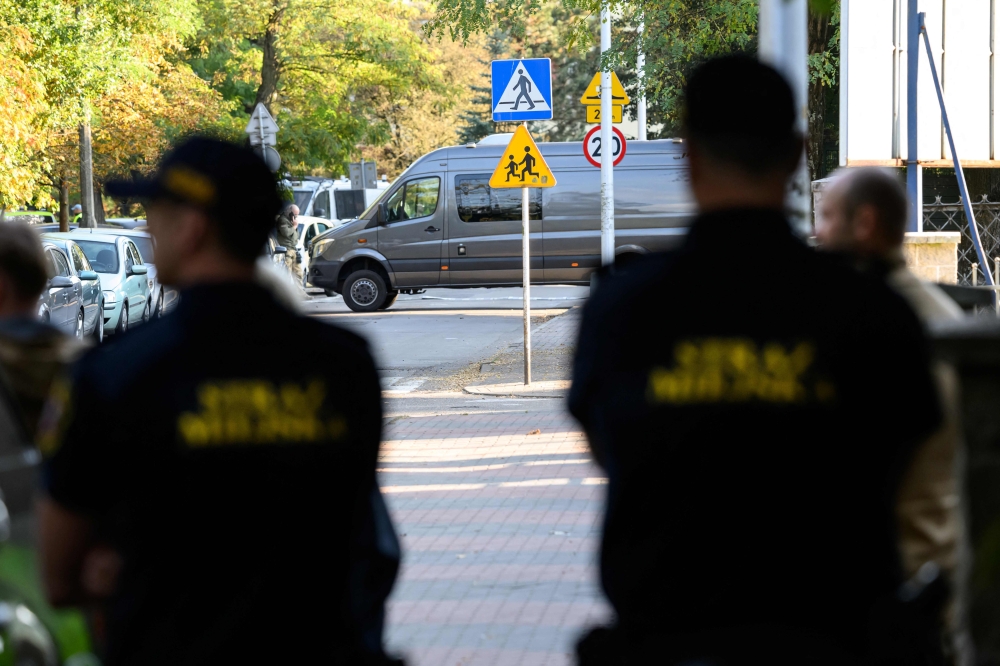 Police officers guard outside the scene of a knife attack at a vocational school in the town of Ostroleka, Poland. (Photo by Mladen ANTONOV / AFP)