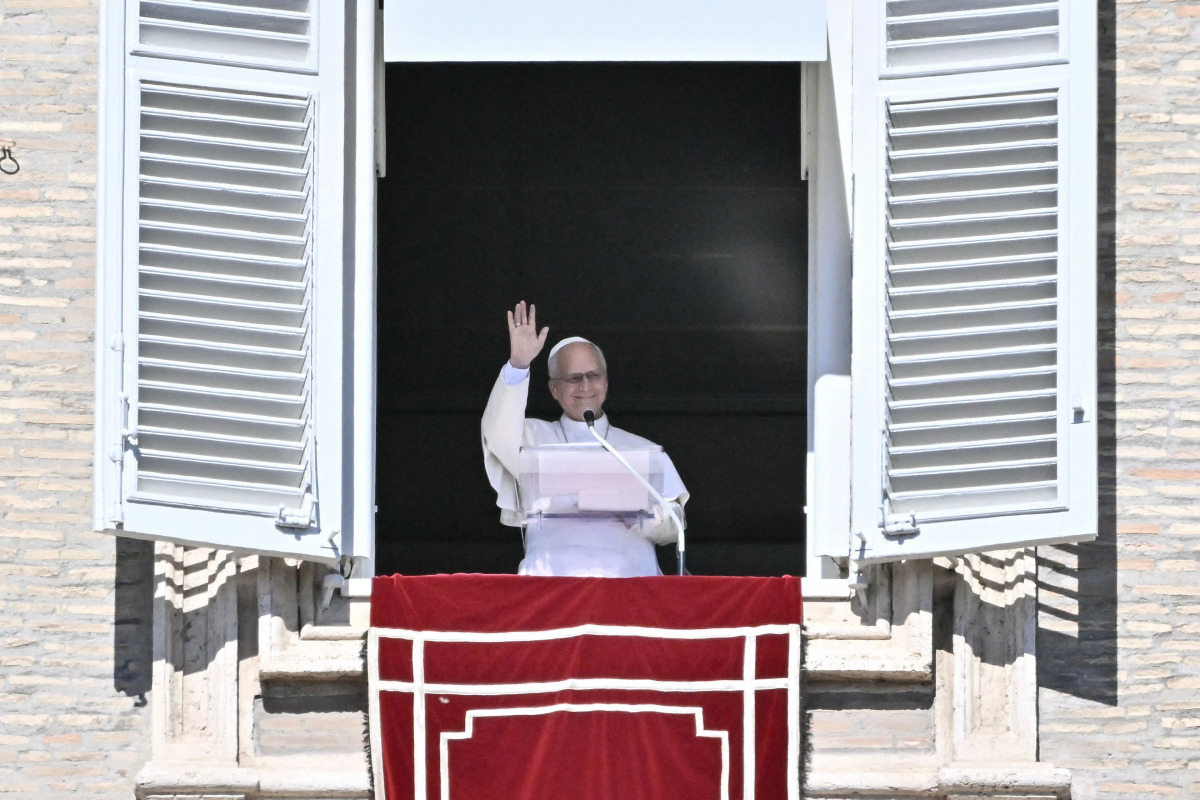 Pope Leo XIV waves to faithful during the Angelus prayer from the window of the Apostolic Palace overlooking St. Peter's Square, in the Vatican, on October 11, 2026. (Photo by Filippo MONTEFORTE / AFP)