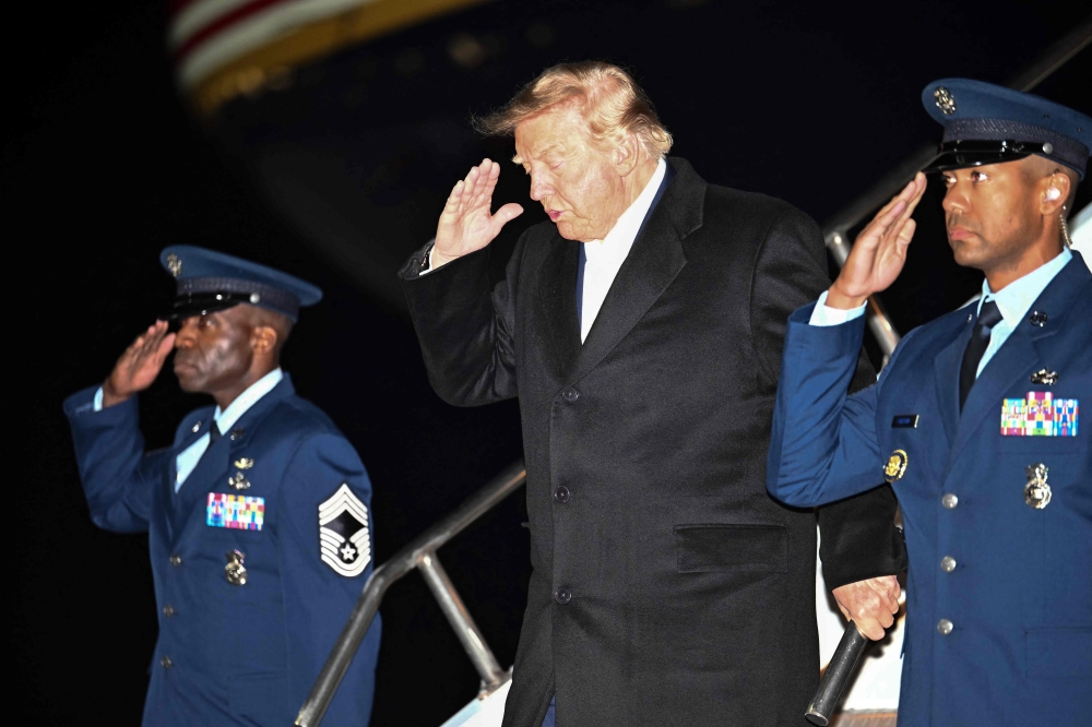 US President Donald Trump disembarks Air Force One upon arrival to Harry Reid International Airport in Las Vegas, Nevada, in the early hours of October 14, 2026. (Photo by Kent Nishimura / AFP)