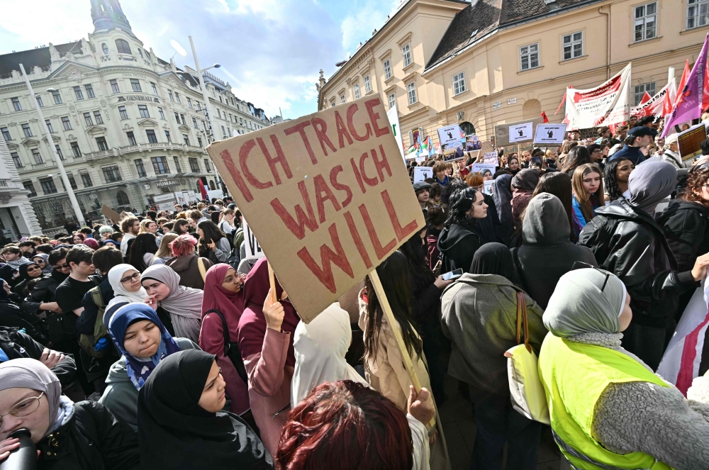 (Files) A protester holds a placard reading 