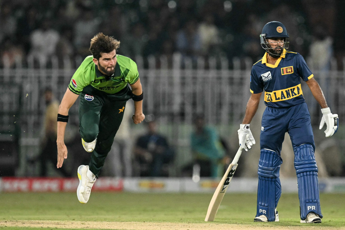 Pakistan's captain Shaheen Shah Afridi (L) bowls as Sri Lanka's Pavan Rathnayake watches during the tri-series one-day international (ODI) cricket match between Pakistan and Sri Lanka at the Rawalpindi Cricket Stadium in Rawalpindi on October 18, 2026. (Photo by Aamir QURESHI / AFP)