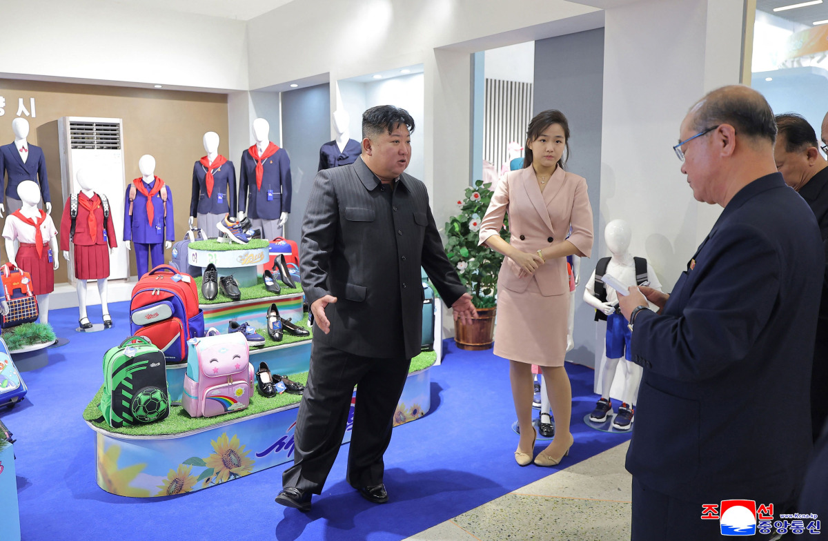 This picture taken on October 19, 2026 and released by North Korea's official Korean Central News Agency (KCNA) on October 20, 2026 shows North Korean leader Kim Jong Un (L) and his daughter Kim Ju Ae (2nd L) inspecting a clothing and footwear exhibition hall in Pyongyang. (Photo by KCNA VIA KNS / AFP) 