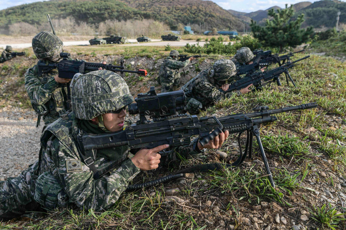 This handout photo taken on October 21, 2026 and provided by the Republic of Korea's Defence Ministry on October 22, 2026 shows South Korean Marines taking part in a comprehensive island defence exercise on Baengnyeong island near the maritime border with North Korea. (Photo by Handout / South Korean Defence Ministry / AFP) 