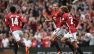 Manchester United's Swedish striker Zlatan Ibrahimovic (2nd L) with Belgian midfielder Marouane Fellaini (R). (AFP / Oli SCARFF)