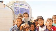 Children in front of a water tank provided by RAF in Iraq.