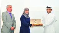 Dr. Hassan Al Derham and Dr. Nitham Hindi honouring Alla El-Awaisi. 