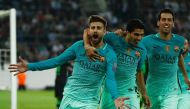 Barcelona's defender Gerard Pique (L) celebrates scoring the 1-2 goal with his teammates Uruguayan forward Luis Suarez and midfielder Sergio Busquets during the UEFA Champions League first-leg group C football match between Borussia Moenchengladbach and F