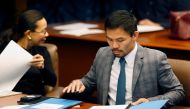 Philippine Senator and boxing champion Manny Pacquiao reads his briefing materials next to fellow Senator Grace Poe, as he prepares for the Senate session in Pasay city, Metro Manila, Philippines. (REUTERS/Erik De Castro/File Photo)