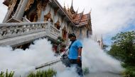 A city worker fumigates the area to control the spread of mosquitoes at a temple in Bangkok, Thailand. Reuters/Chaiwat Subprasom/File Photo