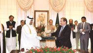 Pakistan Prime Minister Nawaz Sharif witnesses the exchange of documents between Qatar and Pakistan officials after the countries signed the 20-year LNG deal, yesterday.