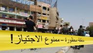 Iraqi security forces corner off the site of a suicide bomb attack at a market in the Baghdad Jadida neighbourhood in the east of the capital on September 27, 2016. AFP / SABAH ARAR