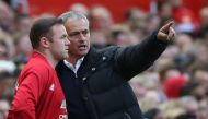 Manchester United's Portuguese manager Jose Mourinho (R) gives instructions to Manchester United's English striker Wayne Rooney as he comes on as a substitute during the English Premier League football match between Manchester United and Stoke City at Old