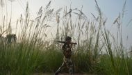  An Indian Border Security Force (BSF) soldier patrols along a fence at the India-Pakistan border in R.S Pora, southwest of Jammu, on October 3, 2016. AFP / TAUSEEF MUSTAFA