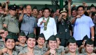 Philippines President Rodrigo Duterte (C) clenches fist with members of the Philippine Army during his visit at the army headquarters in Taguig city, metro Manila, Philippines October 4, 2016. (Reuters / Romeo Ranoco)